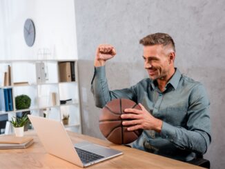 cheerful businessman holding basketball while watc 2022 11 03 19 32 55 utc